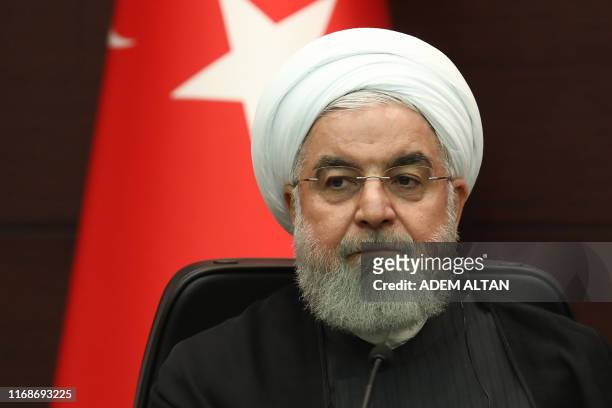 Iranian President Hassan Rouhani speaks during a joint press conference with Turkish and Russian counterparts following a trilateral meeting on...