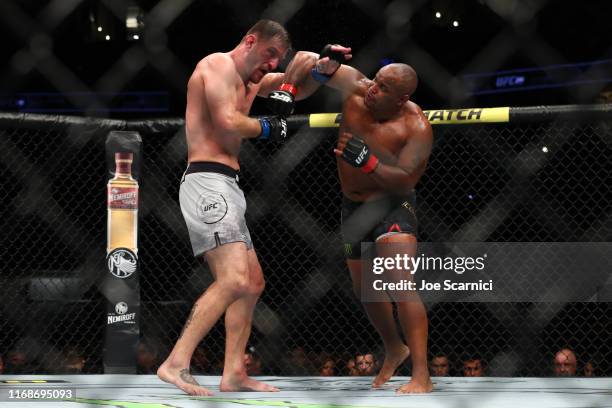 Stipe Miocic and Daniel Cormier get tangled during the third round during their UFC Heavyweight Title Bout at UFC 241 at Honda Center on August 17,...