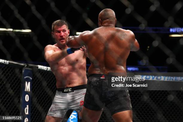 Stipe Miocic and Daniel Cormier in action in the third round during their UFC Heavyweight Title Bout at UFC 241 at Honda Center on August 17, 2019 in...