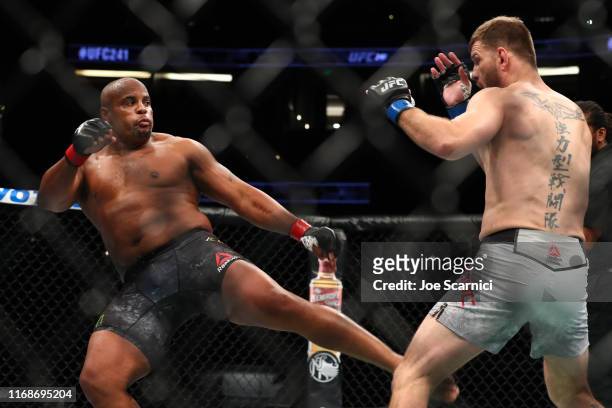 Daniel Cormier kicks Stipe Miocic in the first round during their UFC Heavyweight Title Bout at UFC 241 at Honda Center on August 17, 2019 in...
