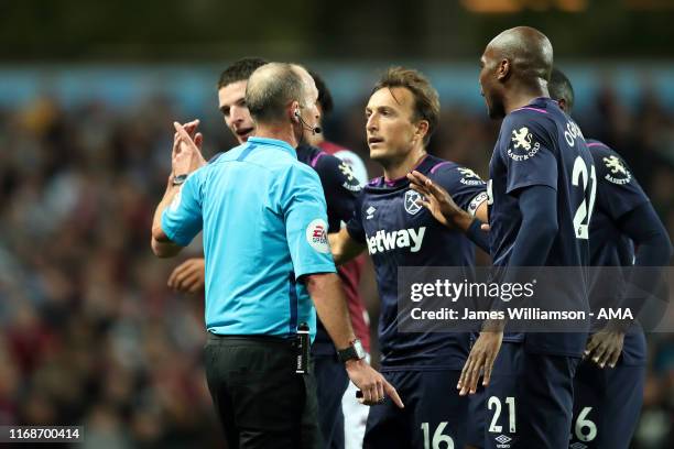 Mark Noble of West Ham United protests to match referee Mike Dean after Arthur Masuaku of West Ham United is sent off for two bookable offences...