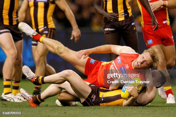 Tom Scully of the Hawks tackles George Horlin-Smith of the Suns during the round 22 AFL match between the Hawthorn Hawks and the Gold Coast Suns at...