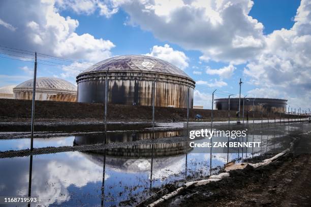 The South Riding Point oil terminal is seen partially destroyed and overflowing in High Rock, Grand Bahama, on September 16, 2019. - Tropical storm...