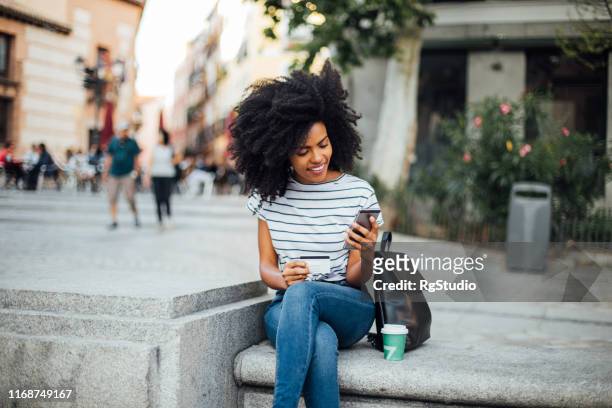 beautiful girl shopping online on the street - happy customer stock pictures, royalty-free photos & images