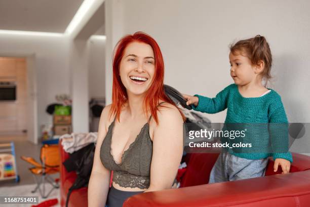 helping mom to comb her hair - baby superhero stock pictures, royalty-free photos & images
