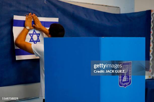 An Israeli man prepares a polling station during Israel's parliamentary election in Rosh Haayin, on September 17, 2019.