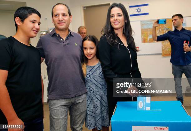 Israel's former justice minister Ayelet Shaked casts her ballot next to family during Israel's parliamentary election at a polling station in Tel...
