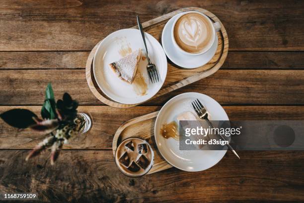 directly above view of coffee and cakes freshly served on the table in cafe - cappuccino top view stock-fotos und bilder