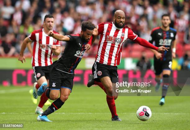David McGoldrick of Sheffield United challenges for the ball with Andros Townsend of Crystal Palace during the Premier League match between Sheffield...