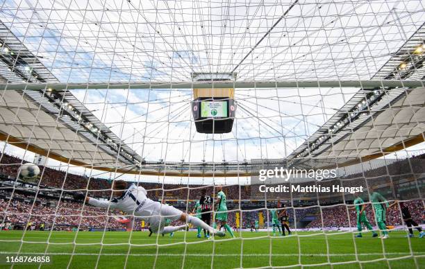 Oliver Baumann of TSG 1899 Hoffenheim fails to stop Martin Hinteregger of Eintracht Frankfurt from scoring his team's first goal during the...