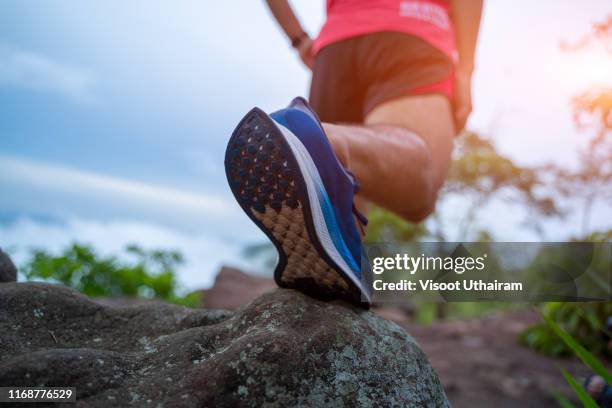 male trail runner running in the forest on a trial. - marathon feet stock pictures, royalty-free photos & images