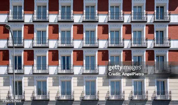 symmetry of lights and shadows on the facade - stockwerk stock-fotos und bilder