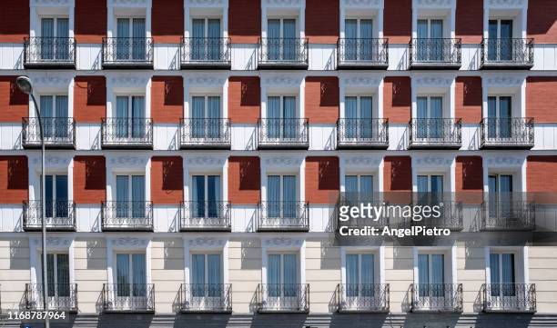 symmetry of lights and shadows on the facade - fachadas imagens e fotografias de stock