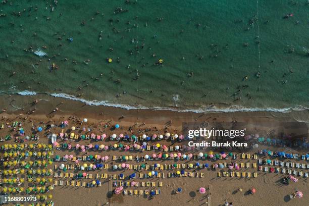 People enjoy Incekum beach on August 18, 2019 in Alanya, Turkey. Turkey’s resort towns saw a 100 percent occupancy rate with the Eid al-Adha holiday,...