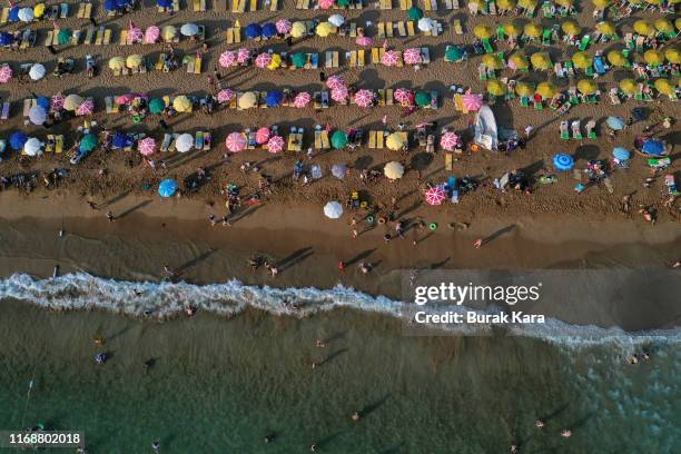 People enjoy Incekum beach on August 18, 2019 in Alanya, Turkey. Turkey’s resort towns saw a 100 percent occupancy rate with the Eid al-Adha holiday,...