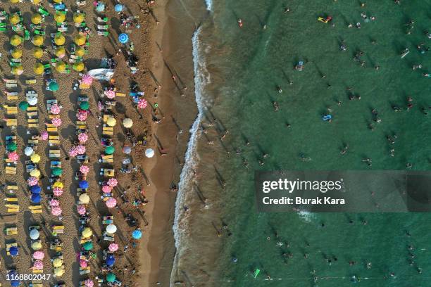 People enjoy Incekum beach on August 18, 2019 in Alanya, Turkey. Turkey’s resort towns saw a 100 percent occupancy rate with the Eid al-Adha holiday,...