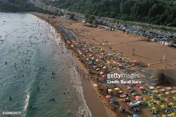 People enjoy Incekum beach on August 18, 2019 in Alanya, Turkey. Turkey’s resort towns saw a 100 percent occupancy rate with the Eid al-Adha holiday,...