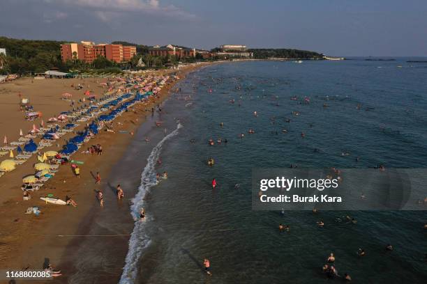 People enjoy Incekum beach on August 18, 2019 in Alanya, Turkey. Turkey’s resort towns saw a 100 percent occupancy rate with the Eid al-Adha holiday,...