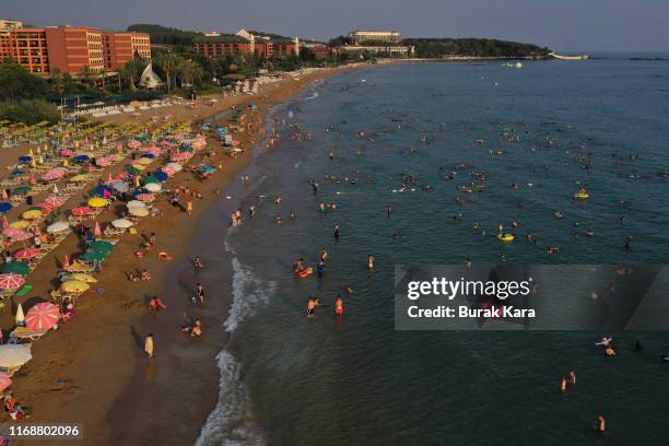 People enjoy Incekum beach on August 18, 2019 in Alanya, Turkey. Turkey’s resort towns saw a 100 percent occupancy rate with the Eid al-Adha holiday,...