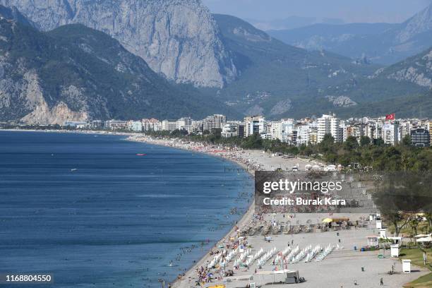 People enjoy Konyaalti beach on August 18, 2019 in Antalya, Turkey. Turkey’s resort towns saw a 100 percent occupancy rate with the Eid al-Adha...