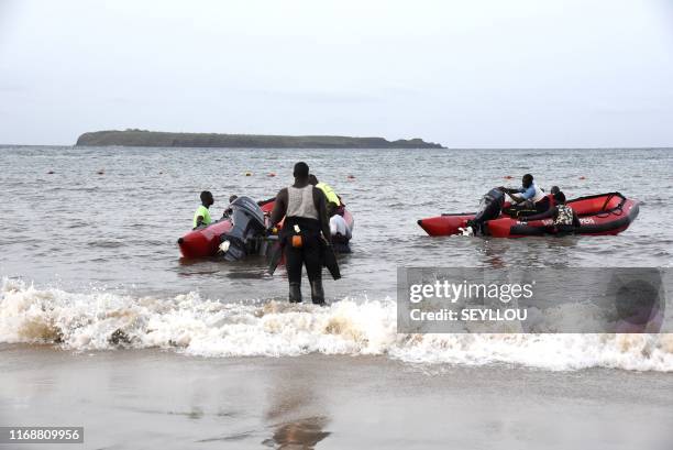 Senegalese emergency workers prepare their boats to leave for a reascue and search mission on a beach of Dakar, near the Madeleine islands, on...