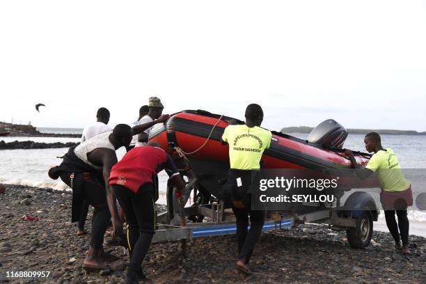 Senegalese emergency workers prepare their boats to leave for a reascue and search mission on a beach of Dakar, near the Madeleine islands, on...