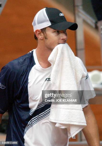 Andy Roddick of USA bites a towel as he reacts to his game against Dominik Hrbaty of Slovakia during Davis cup World group play-off match between...