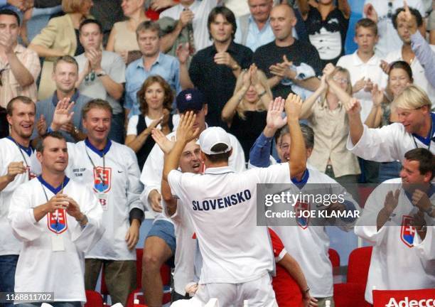 Dominik Hrbaty of Slovakia celebrates with his teammates and fans his victory over US Andy Roddick of US in the Davis cup World group play-off match...