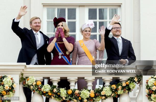 King Willem-Alexander and Queen Maxima, with Prince Constantijn and Princess Laurentien, wave to bystanders from the balcony at Noordeinde Palace in...
