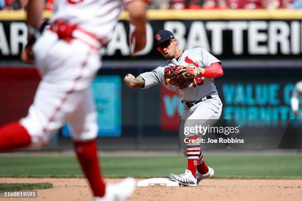 Kolten Wong of the St. Louis Cardinals throws to first to turn a double play with the bases loaded in the seventh inning against the Cincinnati Reds...