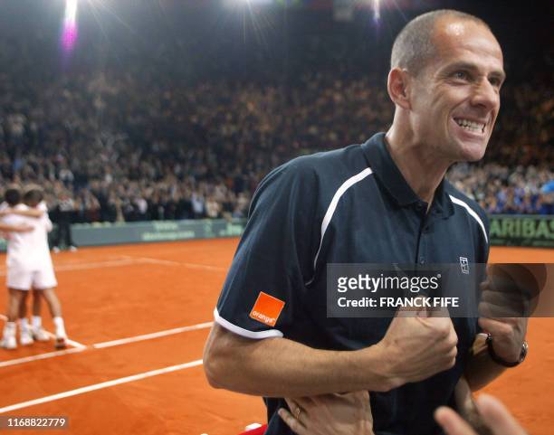 French captain Guy Forget jubilates after France's Fabrice Santoro and Nicolas Escude won against Russia's Marat Safin and Yevgeny Kafelnikov during...