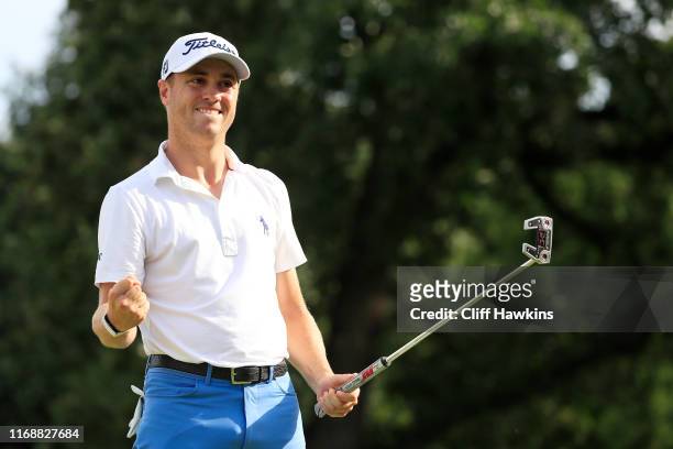Justin Thomas of the United States celebrates on the 18th green after winning during the final round of the BMW Championship at Medinah Country Club...