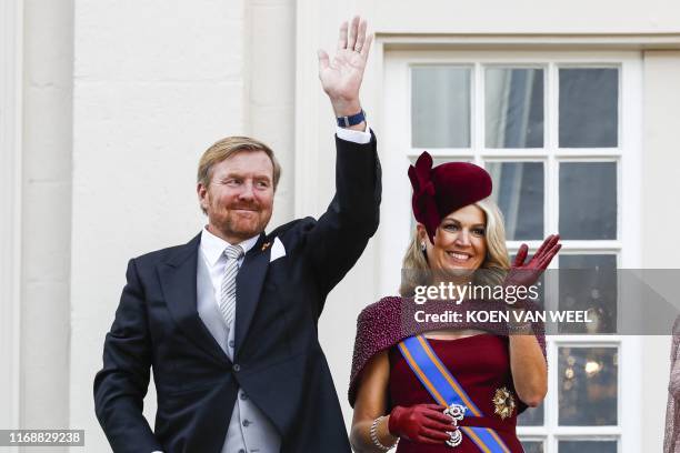 King Willem-Alexander and Queen Maxima wave to bystanders from the balcony at Noordeinde Palace in The Hague on September 17, 2019 on the Prinsjesdag...