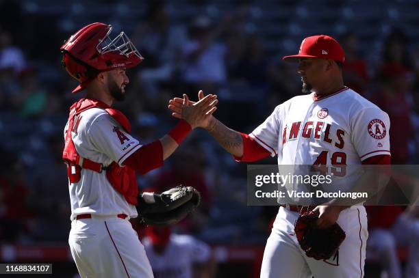 Catcher Anthony Bemboom of the Los Angeles Angels celebrates with closing pitcher Adalberto Mejia after their 9-2 win against the Chicago White Sox...