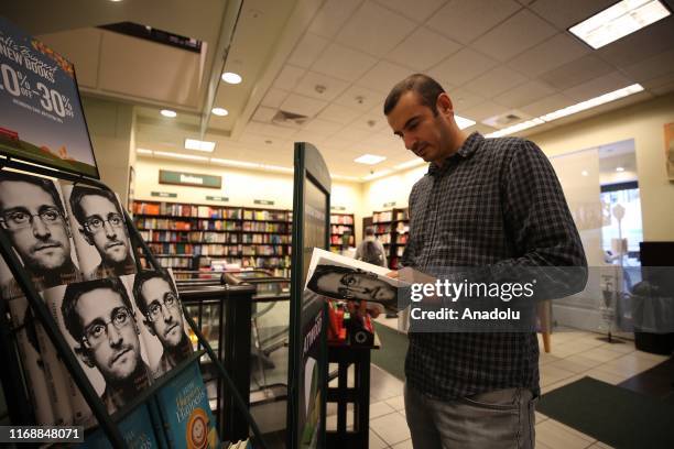 Man views the newly published book 'Permanent Record' by former National Security Agency contractor, Edward Snowden at a bookseller in New York,...