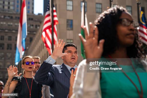 New U.S. Citizens recite the the Oath of Allegiance during a naturalization ceremony at Rockefeller Center on September 17, 2019 in New York City....