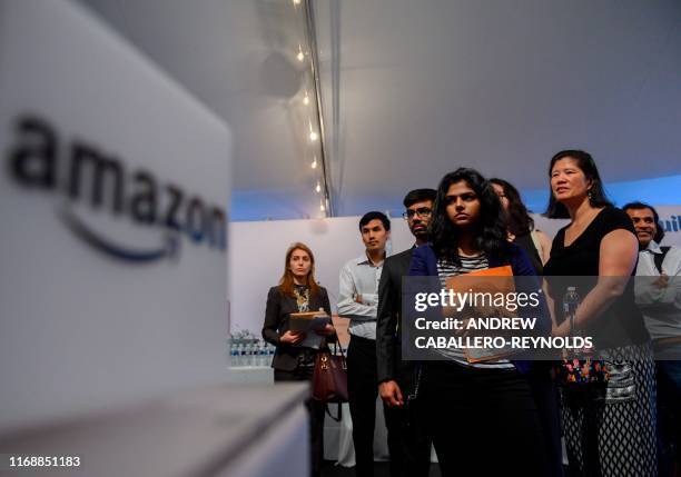 Job hunters wait to speak with Amazon recruiters at an Amazon Career Day event, where recruiters help candidates build interview skills, prepare them...