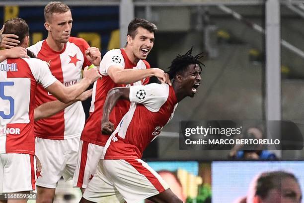 Slavia Prague's Nigerian forward Peter Olayinka celebrates with teammates after scoring during the UEFA Champions League Group F football match Inter...