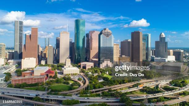 high quality panorama aerial view of downtown houston in texas skyline, with commercial building in a blue sky day. - houston stock pictures, royalty-free photos & images