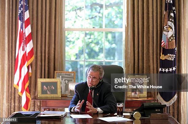 President George W. Bush speaks with Crown Prince Abdallah of Saudi Arabia October 7, 2001 from the Oval Office of the White House in Washington, DC.