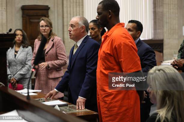 Singer R. Kelly appears standing beside his attorney, Steven Greenberg during a hearing at the Leighton Criminal Courthouse on September 17, 2019 in...