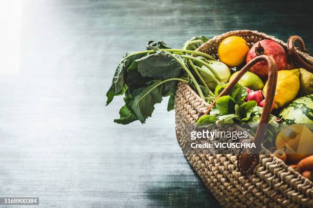 wicker basket with various organic vegetables and fruits from market - basket stock-fotos und bilder