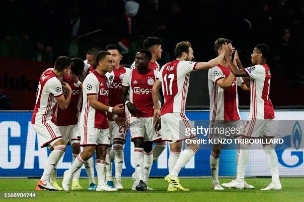 Ajax's Argentine defender Nicolas Tagliafico celebrates with teammates after scoring a goal during the UEFA Champions league Group H football match...