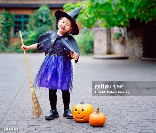 child dressed as witch for halloween - naughty halloween photos et images de collection