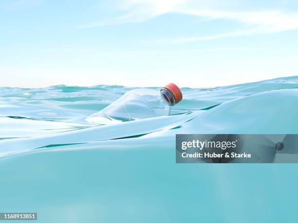 plastic bottle in the sea - water surface stock pictures, royalty-free photos & images