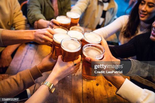 londoners group of friends meet up in a pub - english pub stock pictures, royalty-free photos & images