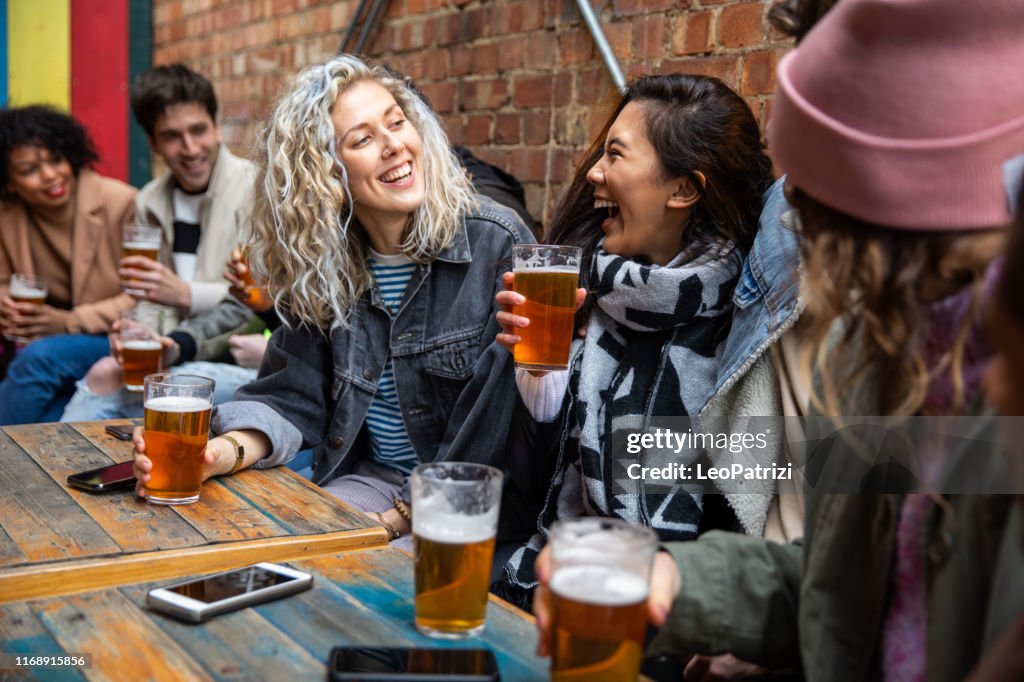 Londoners group of friends meet up in a pub