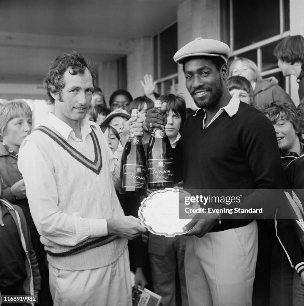 English first-class cricketer Mike Smedley hands to Antiguan cricketer Viv Richards his silver plate prize for 'Evening Standard, Cricketer of the...