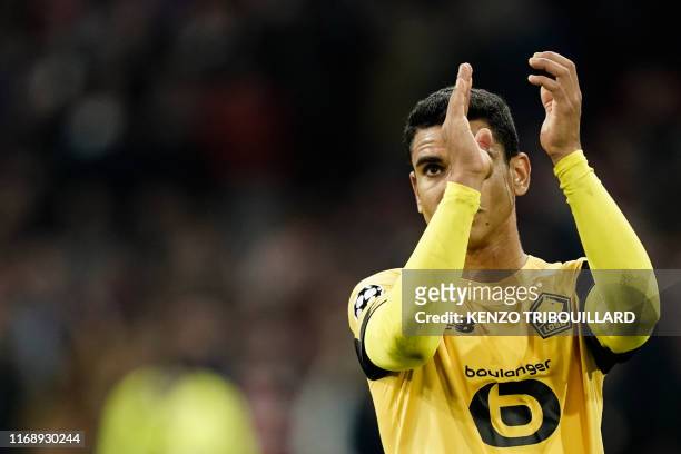 Lille's French midfileder Benjamin Andre applauds at end of the UEFA Champions league Group H football match between Ajax FC Amsterdam and LOSC...