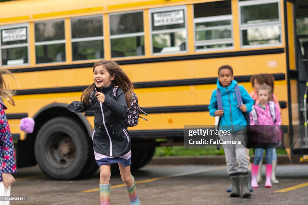 Getting Off Diverse Group Of Happy Children Getting Off School Bus High-Res Stock ...
